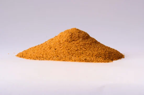 Warm golden-brown spice powder mound, finely textured, ideal for culinary creations and flavor enhancement.
